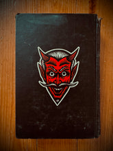 Load image into Gallery viewer, Devil Sticker on old black book